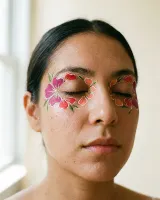AI-generated reference for the Floral mask idea: painted magenta, red and coral petals around both eyes